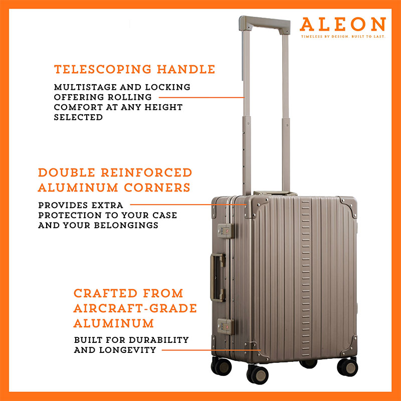 A polished aluminum ALEON 21" Carry-On stands upright on a glossy airport floor, reflecting ambient lighting. Its durable, hard-shell construction and smooth wheels embody modern travel efficiency.