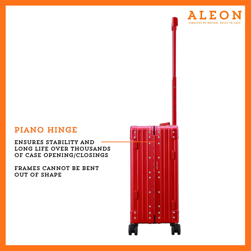 B07499SXCK-RU-Hinge-(2) A polished red ruby aluminum ALEON 21" Carry-On stands upright on a glossy airport floor, reflecting ambient lighting. Its durable, hard-shell construction and smooth wheels embody modern travel efficiency.