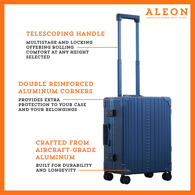 A polished aluminum ALEON 21" Carry-On stands upright on a glossy airport floor, reflecting ambient lighting. Its durable, hard-shell construction and smooth wheels embody modern travel efficiency.