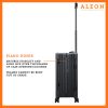 B079VMSMN7-ON-Hinge-(2) A polished onyx aluminum ALEON 21" Carry-On stands upright on a glossy airport floor, reflecting ambient lighting. Its durable, hard-shell construction and smooth wheels embody modern travel efficiency.