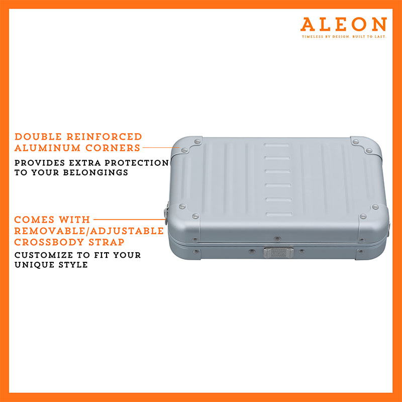 ALEON platinum silver crossbody case displayed with highlighted features, including double reinforced aluminum corners for enhanced durability and an aluminum clasp for secure closure. The case is open, revealing organized interior compartments. Brand name 'ALEON' and tagline 'TIMELESS BY DESIGN. BUILT TO LAST.' are shown at the top right.