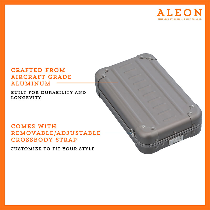 Aleon vertical bronze crossbody bag designed with aircraft-grade aluminum for lasting durability. The bag features an adjustable and removable strap for personalized styling. Aleon logo and tagline 'Timeless by design. Built to last.' are prominently displayed against a clean white background accented with orange borders.