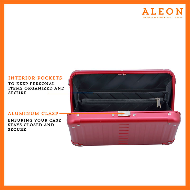ALEON large red ruby crossbody case displayed with highlighted features, including double reinforced aluminum corners for enhanced durability and an aluminum clasp for secure closure. The case is open, revealing organized interior compartments. Brand name 'ALEON' and tagline 'TIMELESS BY DESIGN. BUILT TO LAST.' are shown at the top right.